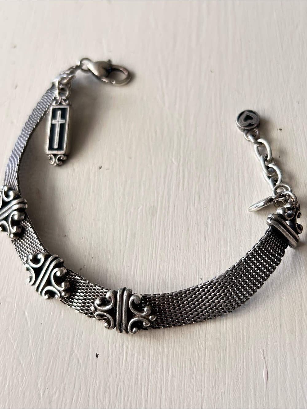 Brighton silver mesh bracelet with decorative filigree links and a cross charm